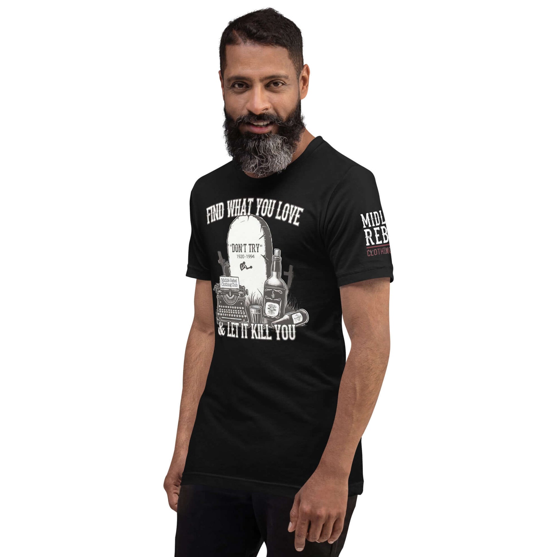 Man wearing a black Bukowski tribute shirt with tombstone, whiskey bottles, and typewriter design. Midlife Rebel Collection.