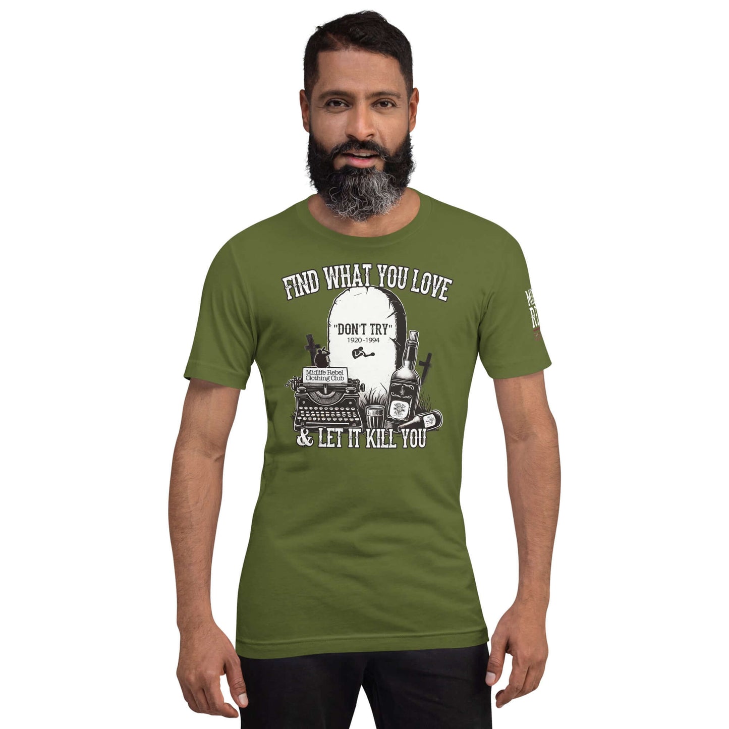 Man wearing a green shirt with "Find What You Love & Let It Kill You" design featuring tombstone, whiskey, and typewriter.