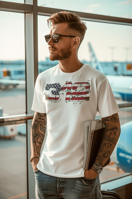 312-midlife-rebel-clothing club-man-with-arm-tattoos-wearing-a-t-shirt-and-sunglasses-at-an-airport