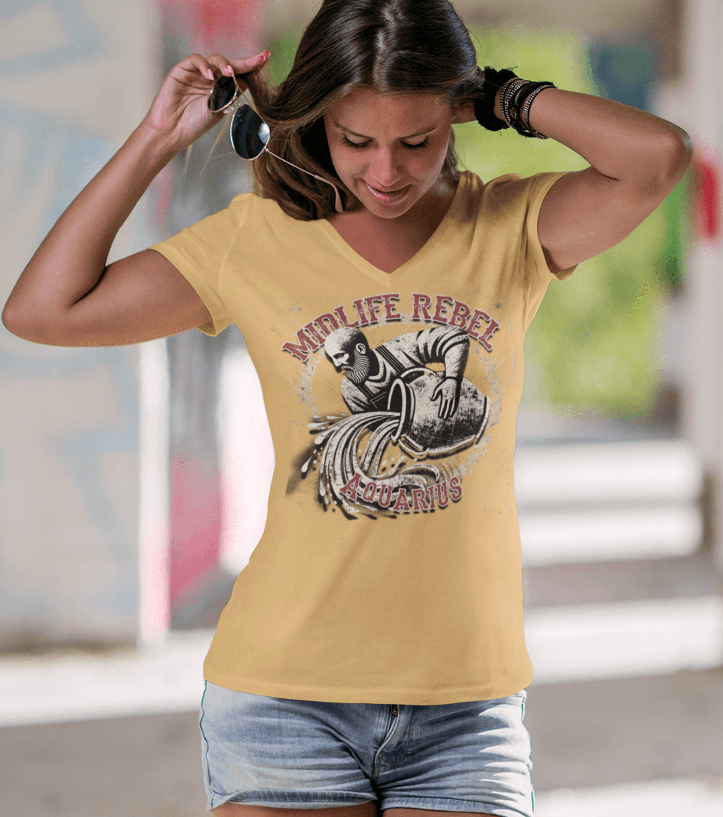 Woman wearing a Midlife Rebel Aquarius Water Bearer T-shirt, highlighting innovative and rebellious style in casual streetwear.