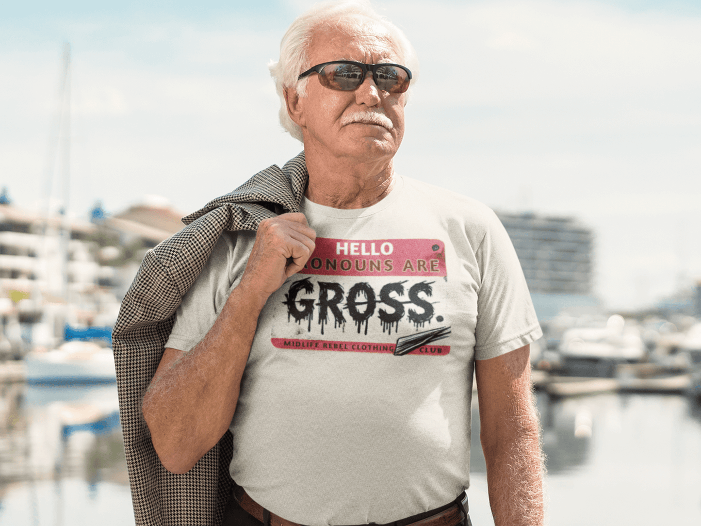 Midlife-Rebel-Clothing-Club-Pronouns_Are-Gross-man-standing-on-a-deck-at-the-marina